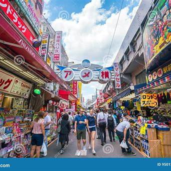 Crowds shopping in Ameyoko Market Street in Ueno, Tokyo, surrounded by colorful signs and local shops