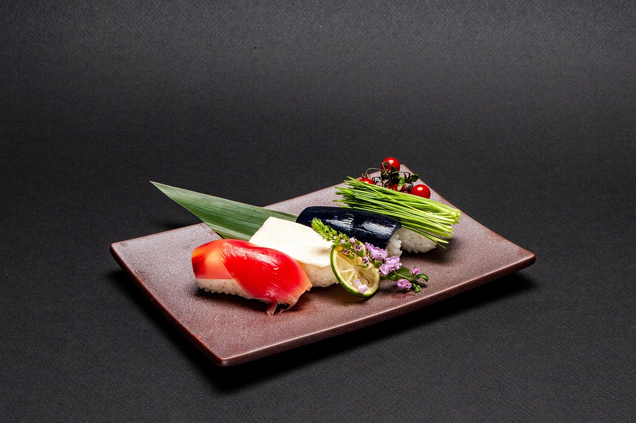 Elegant Japanese kaiseki-style dish with sushi and seasonal vegetables on a black background