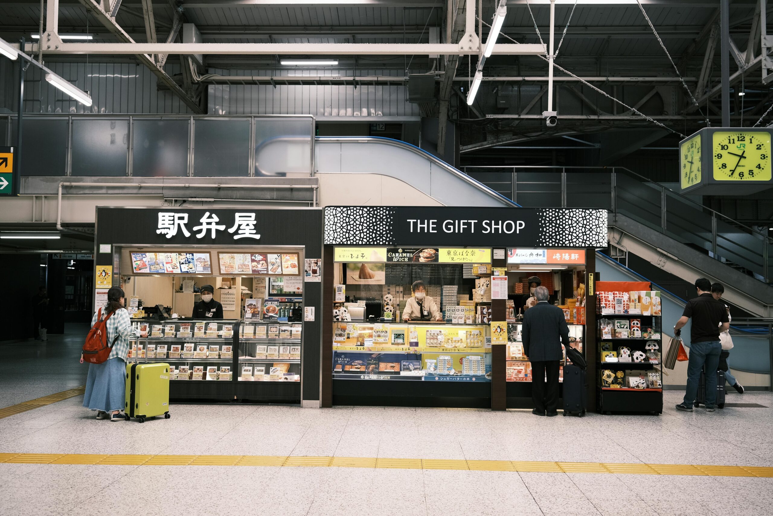 Souvenir and bento shops inside a Japanese train station, offering local snacks and gifts for travelers