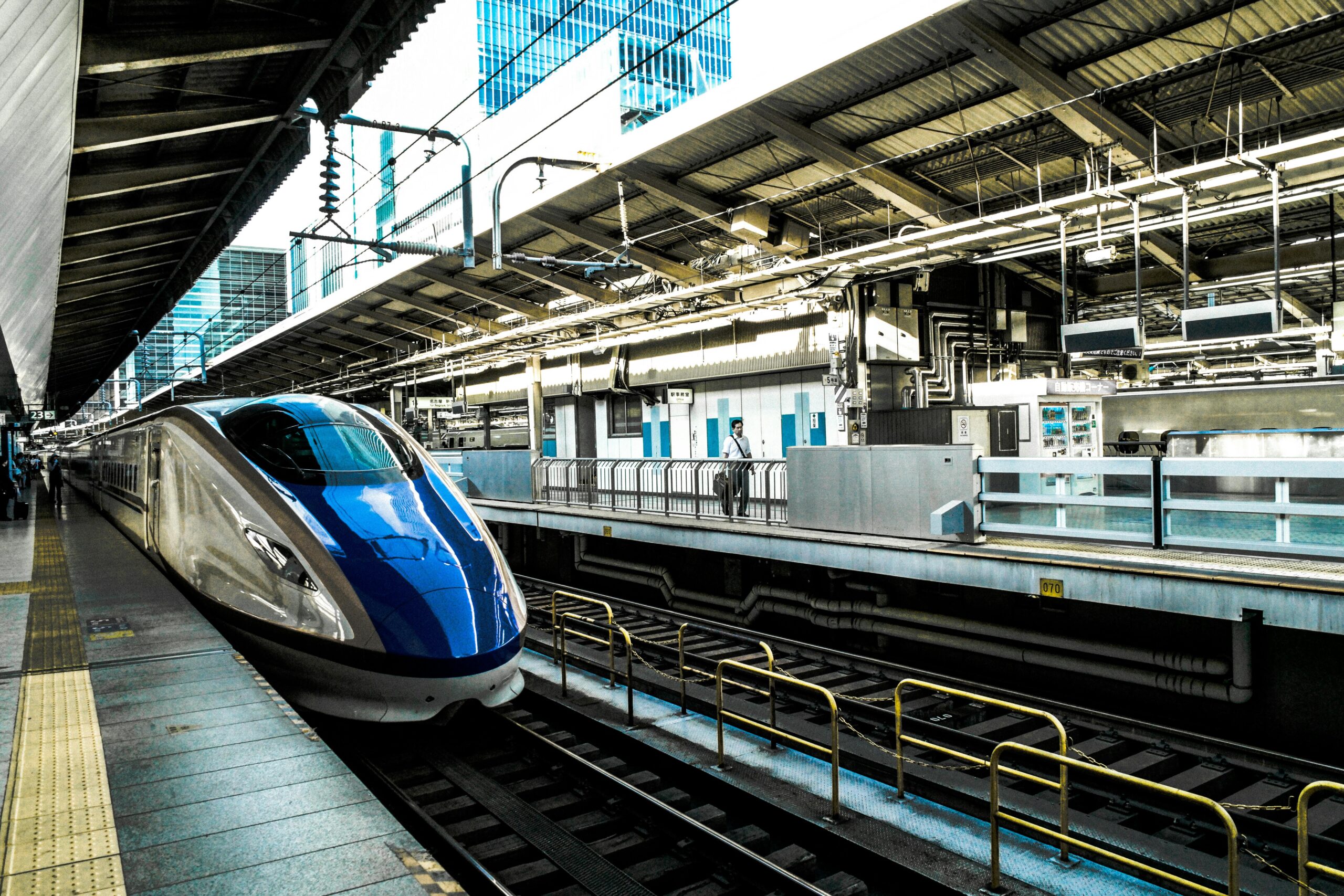 Shinkansen bullet train at a modern Japanese station platform, ready for departure